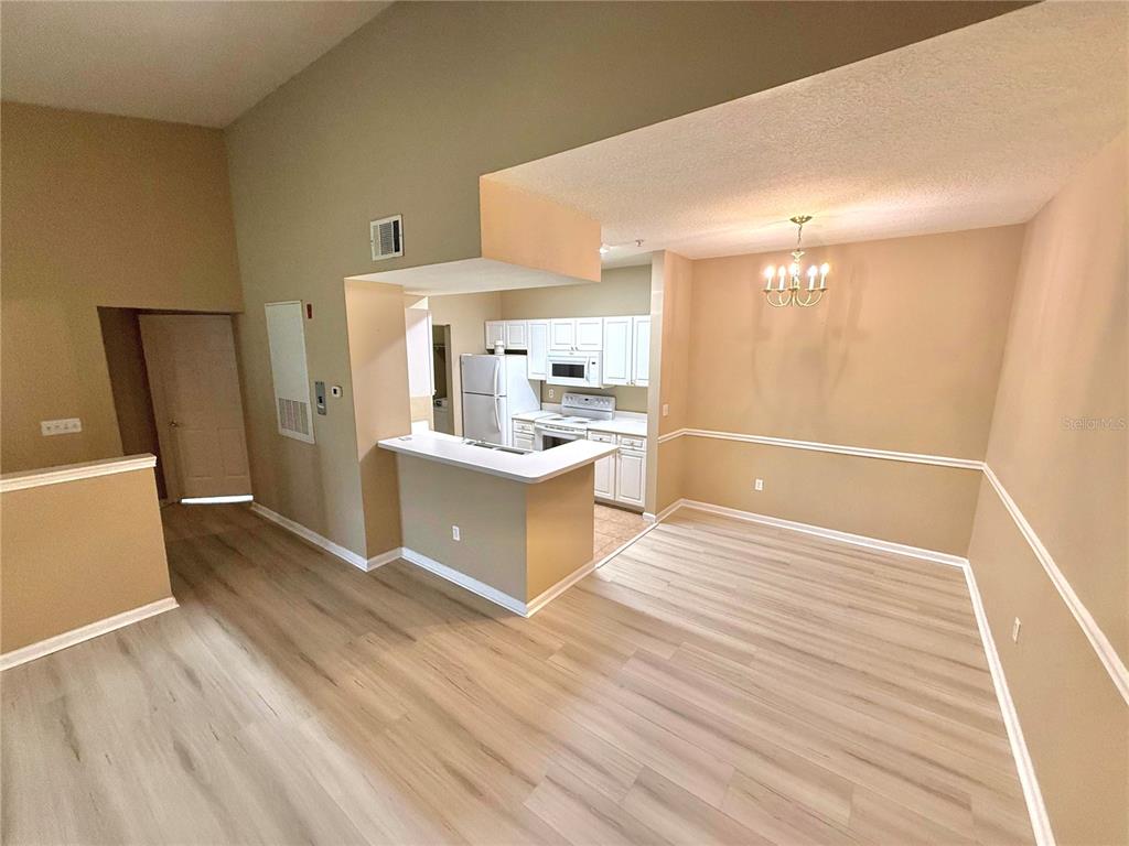 14226 Fredricksburg Drive, Unit 212 Orlando, FL 32837 - Photo 11 of 32 a view of a kitchen cabinets and wooden floor