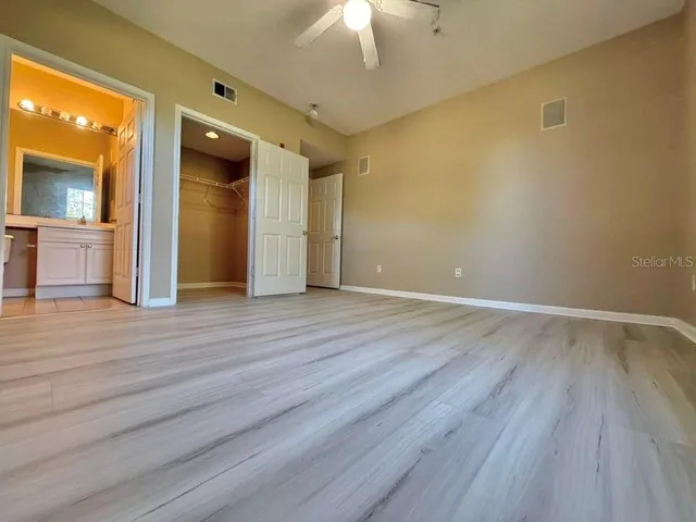 a view of an empty room and wooden floor