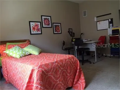 a bedroom with a bed and a desk