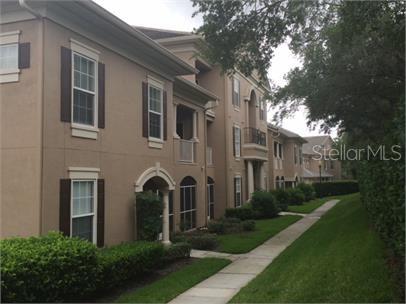 14226 Fredricksburg Drive, Unit 212 Orlando, FL 32837 - Photo 2 of 32 a front view of a house with yard and green space