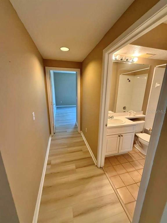 14226 Fredricksburg Drive, Unit 212 Orlando, FL 32837 - Photo 22 of 32 a view of a hallway with wooden floor and staircase