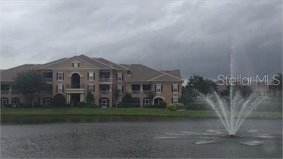 14226 Fredricksburg Drive, Unit 212 Orlando, FL 32837 - Photo 28 of 32 a front view of a house with a garden and yard