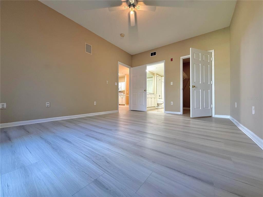 14226 Fredricksburg Drive, Unit 212 Orlando, FL 32837 - Photo 32 of 32 a view of an empty room with wooden floor and a window