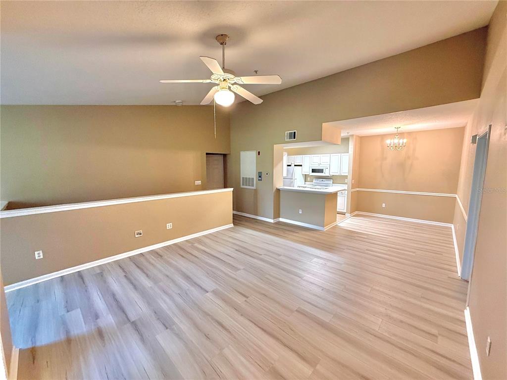 14226 Fredricksburg Drive, Unit 212 Orlando, FL 32837 - Photo 8 of 32 wooden floor in an empty room with a window