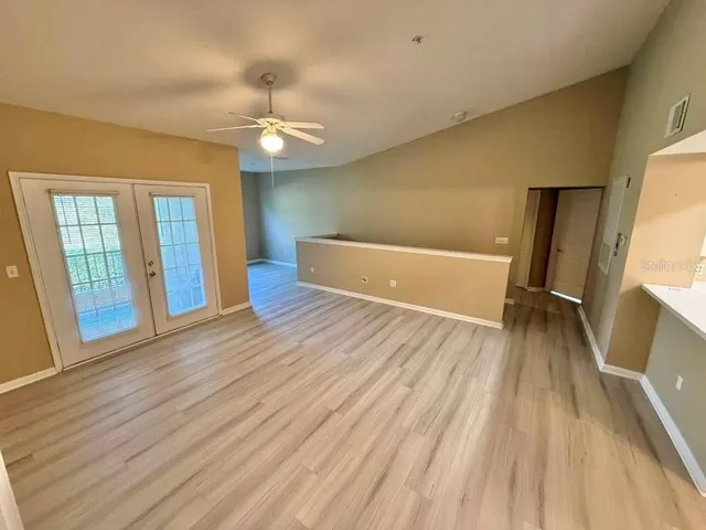 wooden floor in an empty room with a window