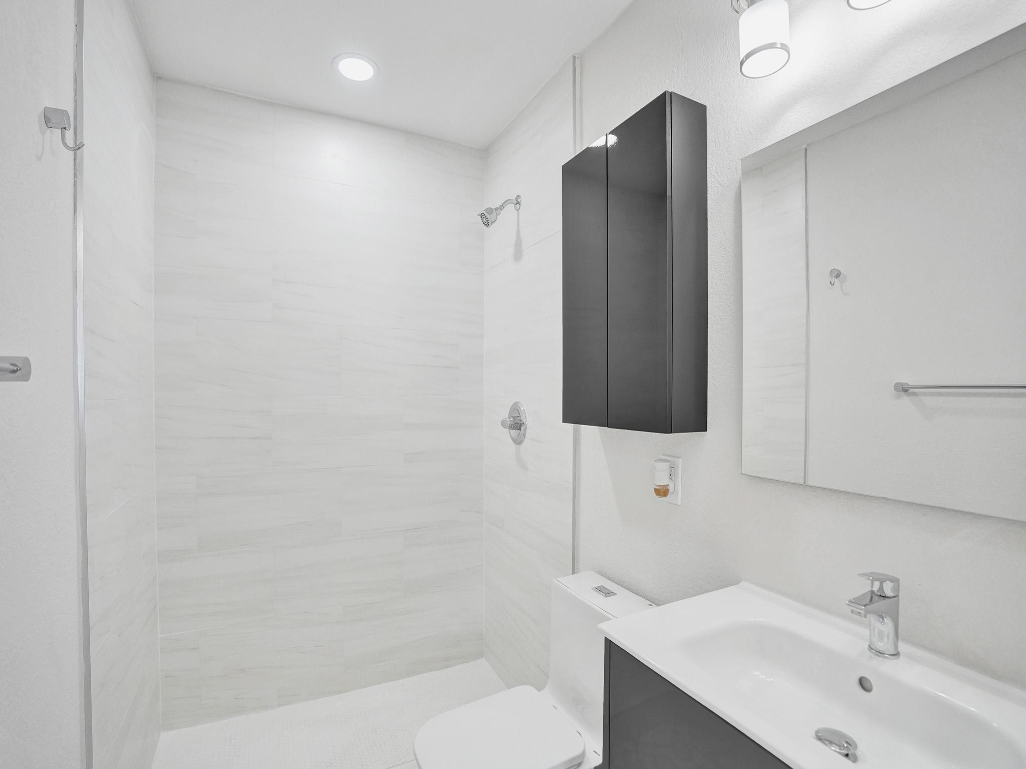 631 North 69th Terrace Hollywood, FL 33024 - Photo 12 of 60 a bathroom with a sink toilet and shower