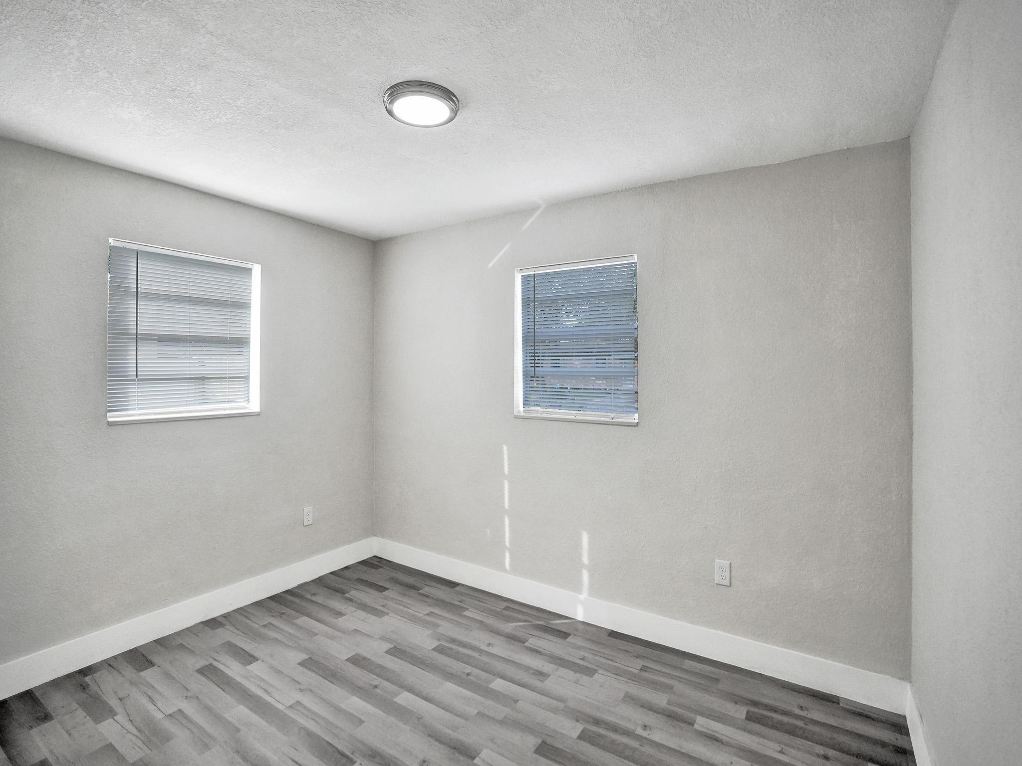 631 North 69th Terrace Hollywood, FL 33024 - Photo 20 of 60 an empty room with wooden floor and windows