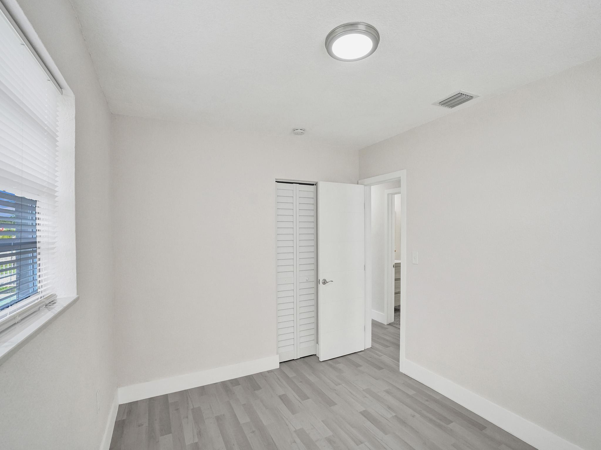 631 North 69th Terrace Hollywood, FL 33024 - Photo 22 of 60 a view of an empty room with closet and a window
