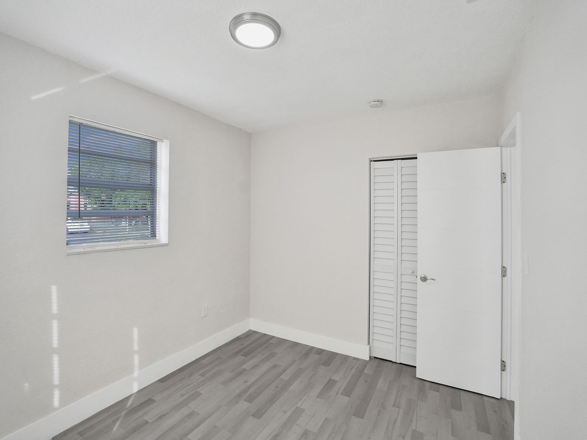 631 North 69th Terrace Hollywood, FL 33024 - Photo 24 of 60 an empty room with wooden floor and windows