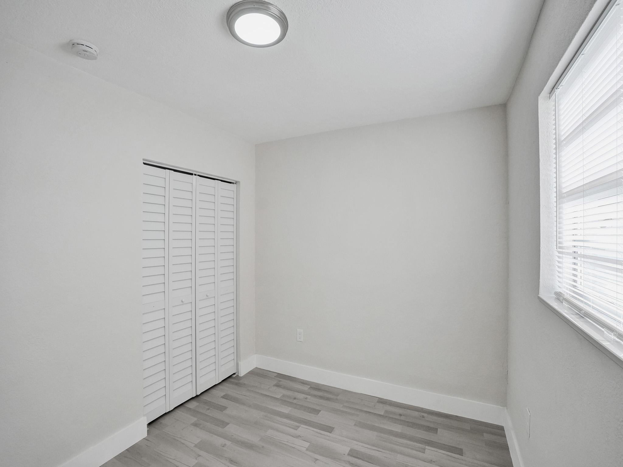 631 North 69th Terrace Hollywood, FL 33024 - Photo 29 of 60 an empty room with wooden floor and windows