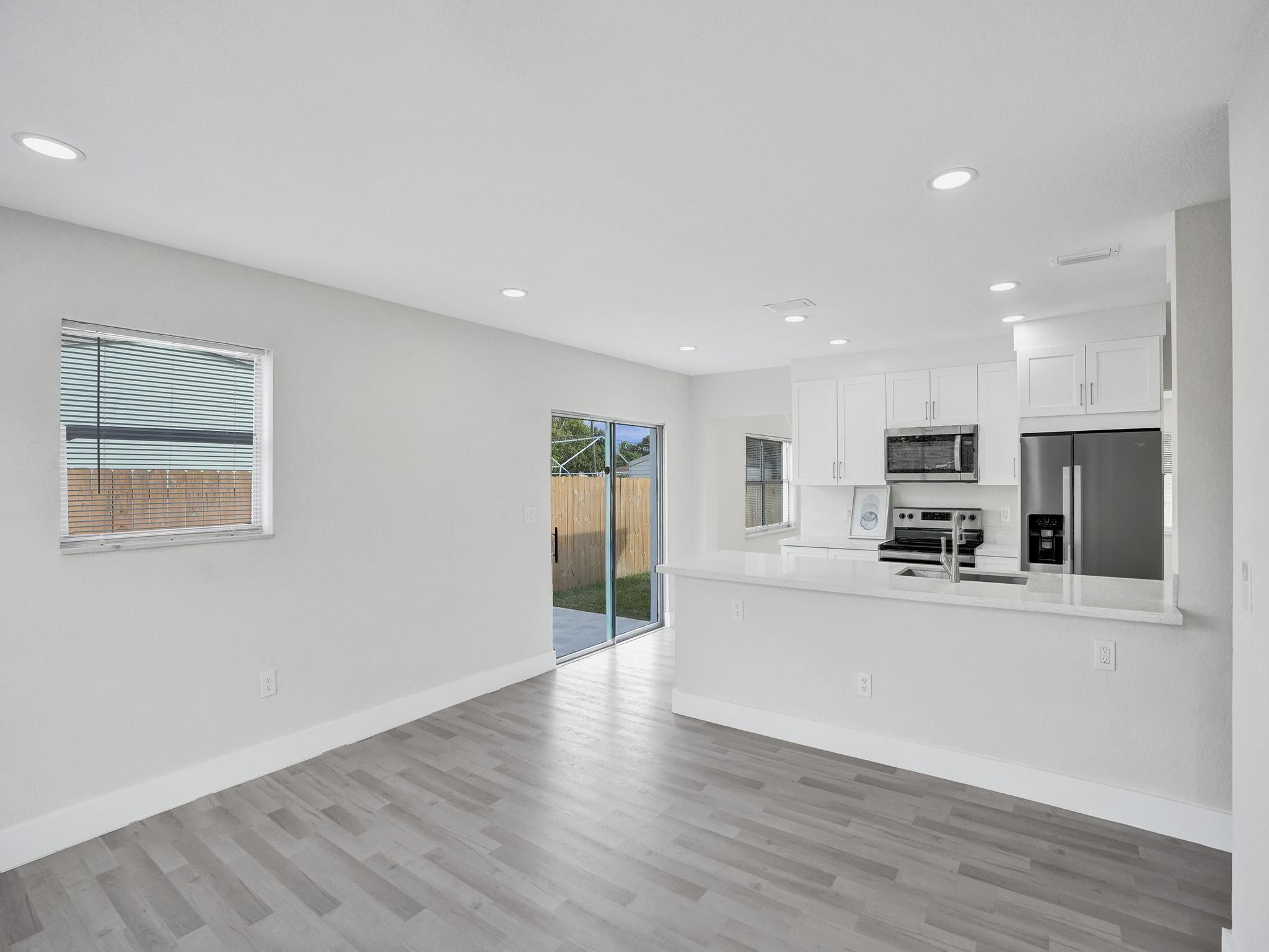 631 North 69th Terrace Hollywood, FL 33024 - Photo 34 of 60 a view of a kitchen with a sink wooden cabinets and a refrigerator