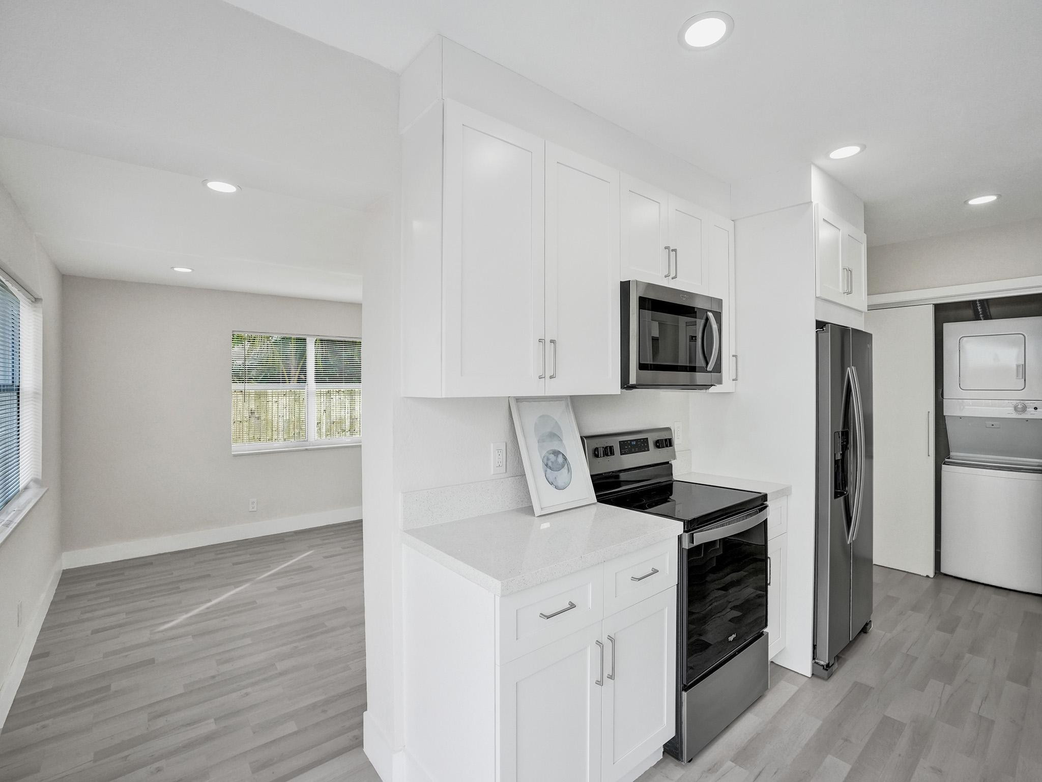 631 North 69th Terrace Hollywood, FL 33024 - Photo 38 of 60 a kitchen with a refrigerator stove and wooden floor