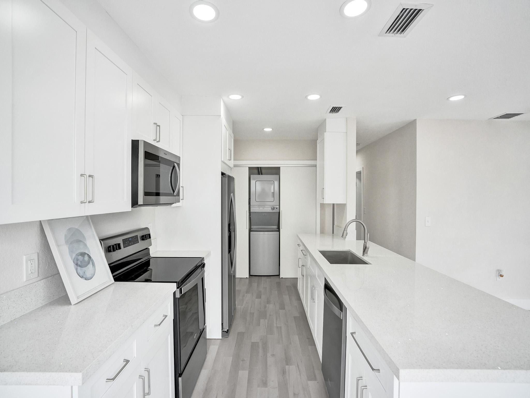 631 North 69th Terrace Hollywood, FL 33024 - Photo 40 of 60 a kitchen with a sink a counter top space stainless steel appliances and cabinets