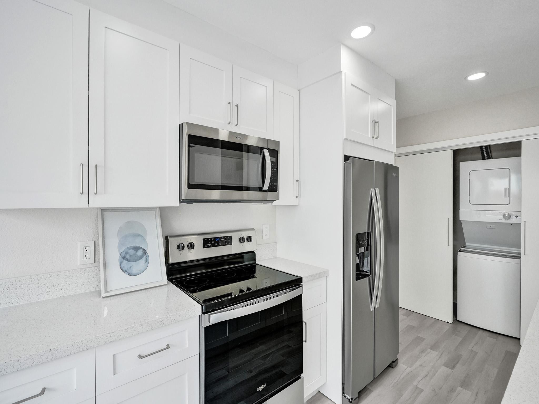 631 North 69th Terrace Hollywood, FL 33024 - Photo 41 of 60 a kitchen with stainless steel appliances a stove microwave and a refrigerator