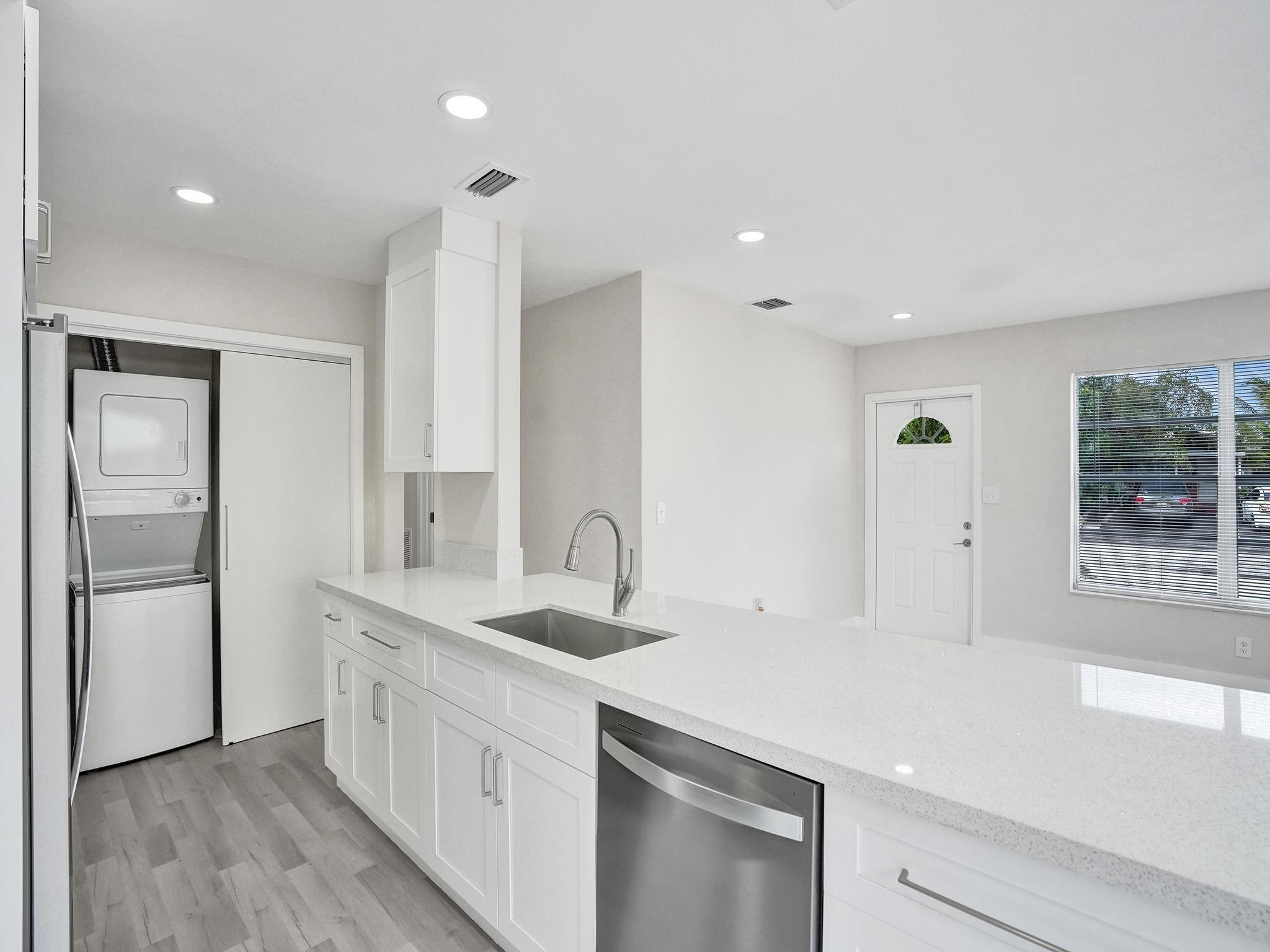 631 North 69th Terrace Hollywood, FL 33024 - Photo 42 of 60 a kitchen with a sink and refrigerator