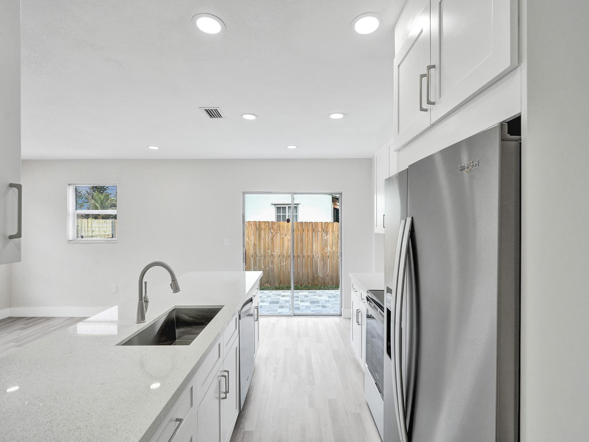 631 North 69th Terrace Hollywood, FL 33024 - Photo 44 of 60 a view of a kitchen with a sink and refrigerator