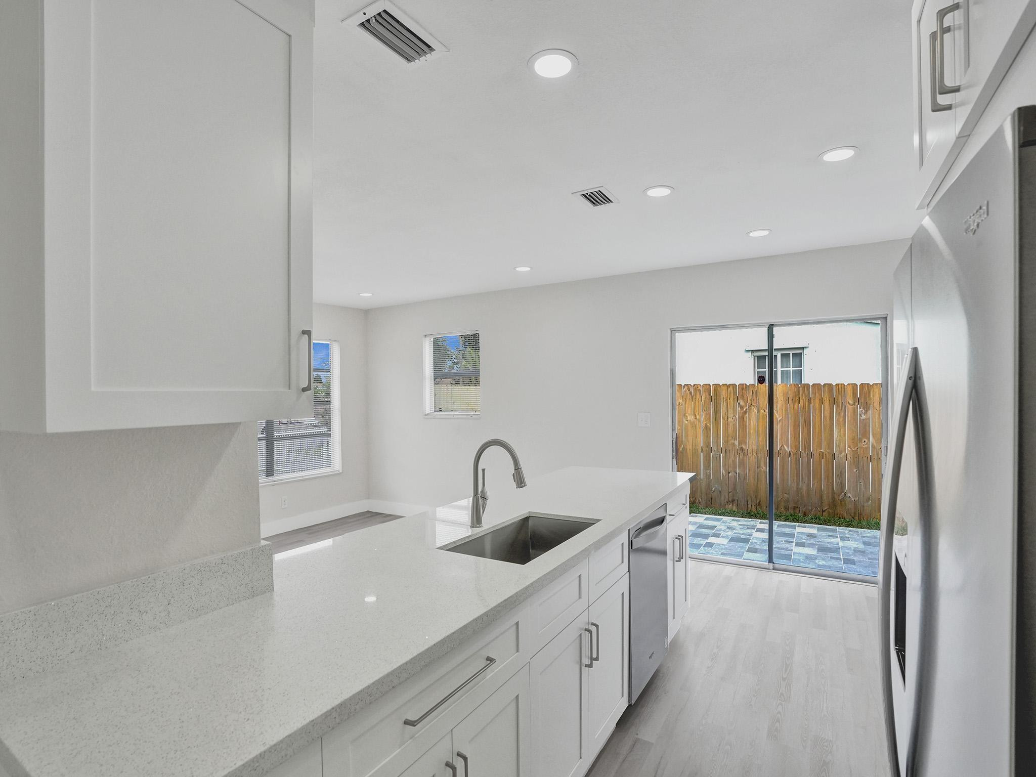 631 North 69th Terrace Hollywood, FL 33024 - Photo 45 of 60 a kitchen with a sink and a refrigerator