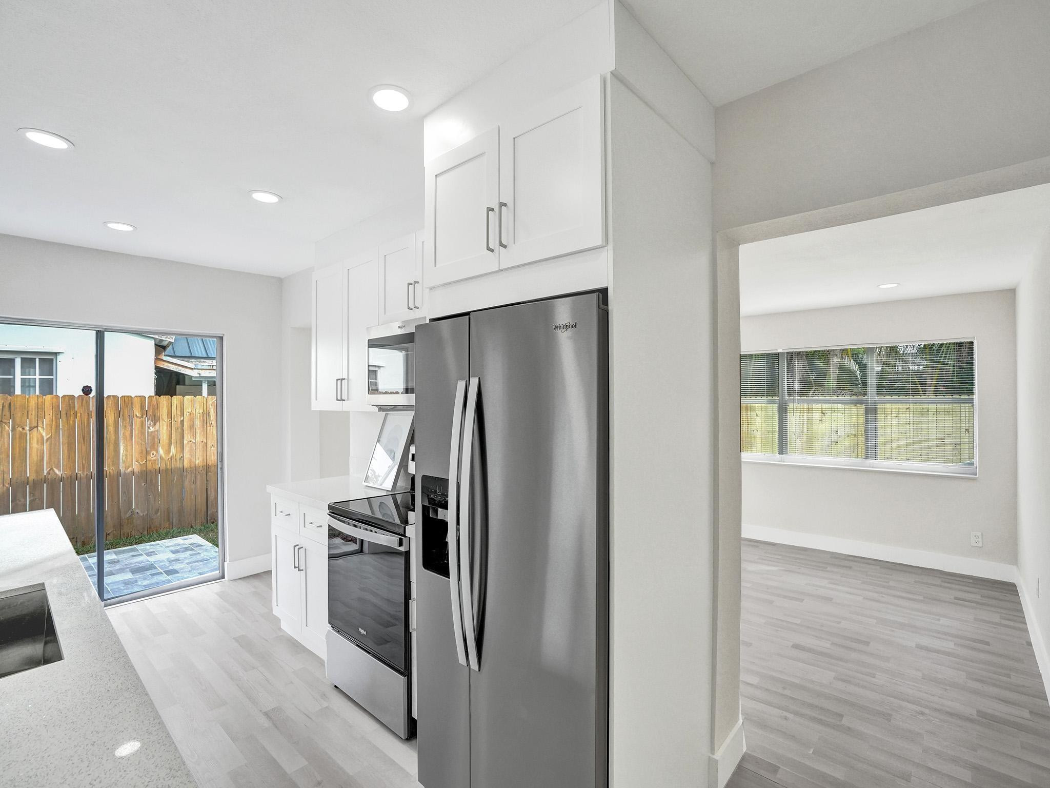 631 North 69th Terrace Hollywood, FL 33024 - Photo 48 of 60 a kitchen with stainless steel appliances a refrigerator sink and cabinets