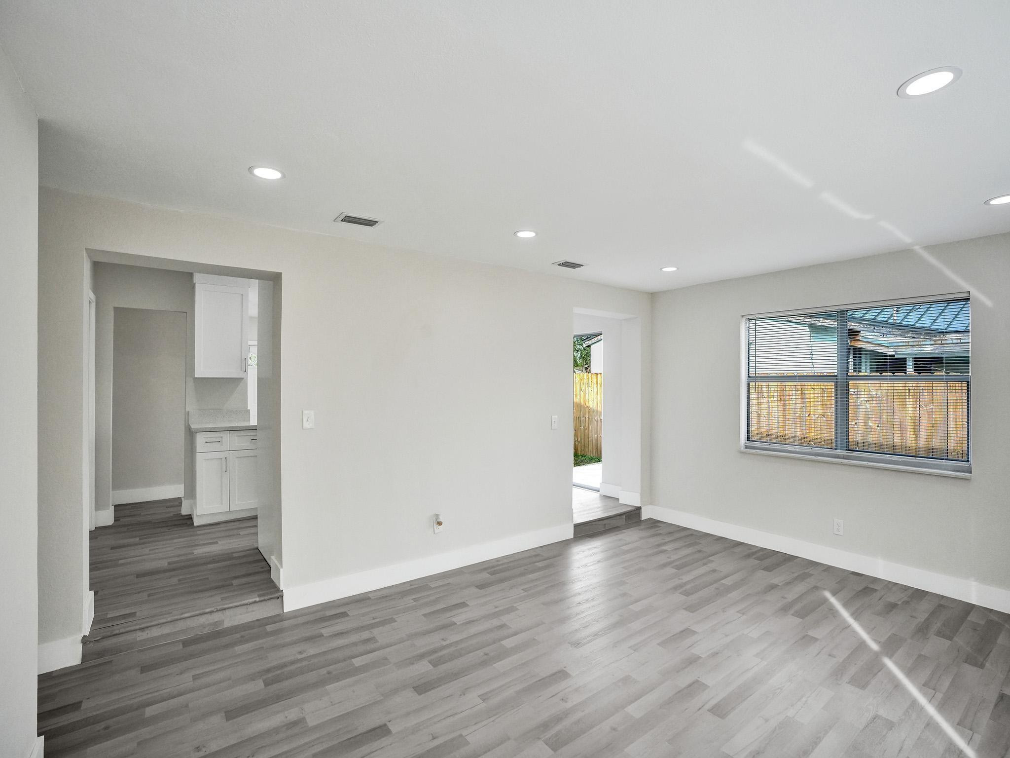 631 North 69th Terrace Hollywood, FL 33024 - Photo 49 of 60 an empty room with wooden floor and windows