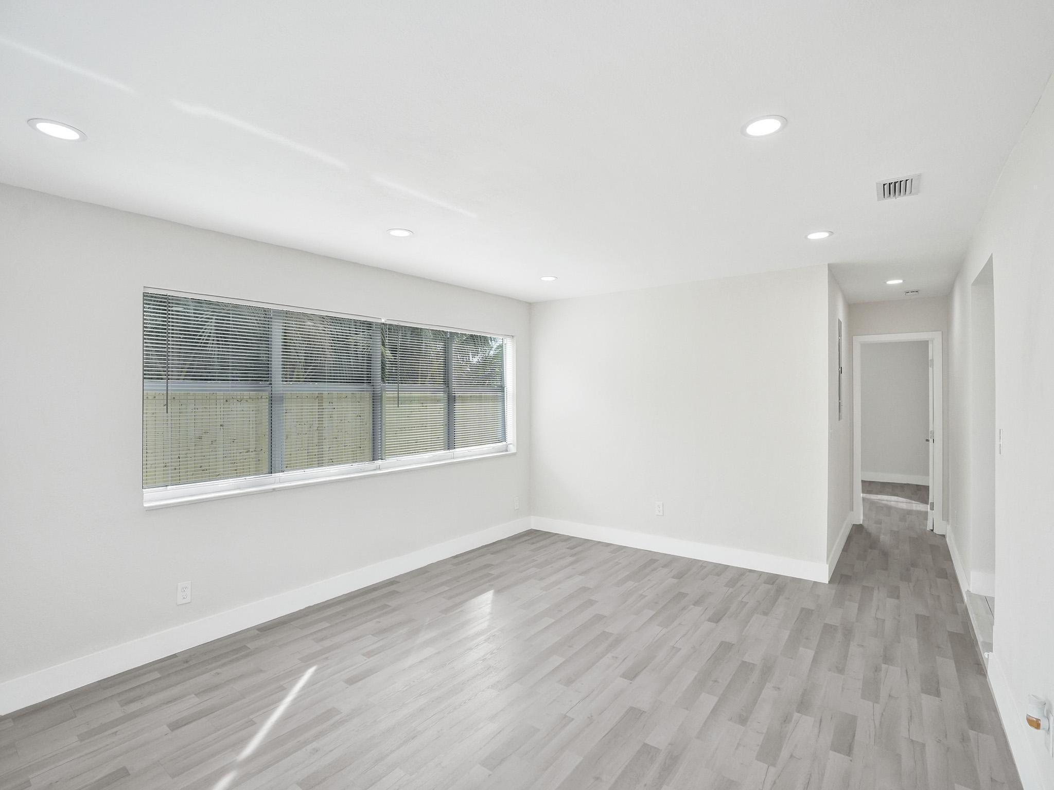 631 North 69th Terrace Hollywood, FL 33024 - Photo 52 of 60 an empty room with wooden floor and windows
