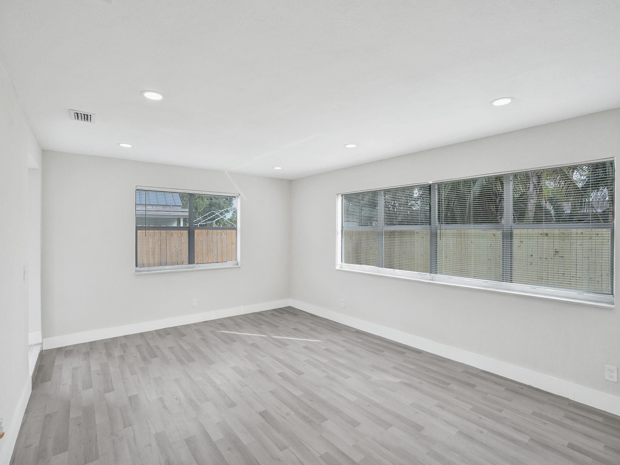 631 North 69th Terrace Hollywood, FL 33024 - Photo 53 of 60 an empty room with wooden floor and windows