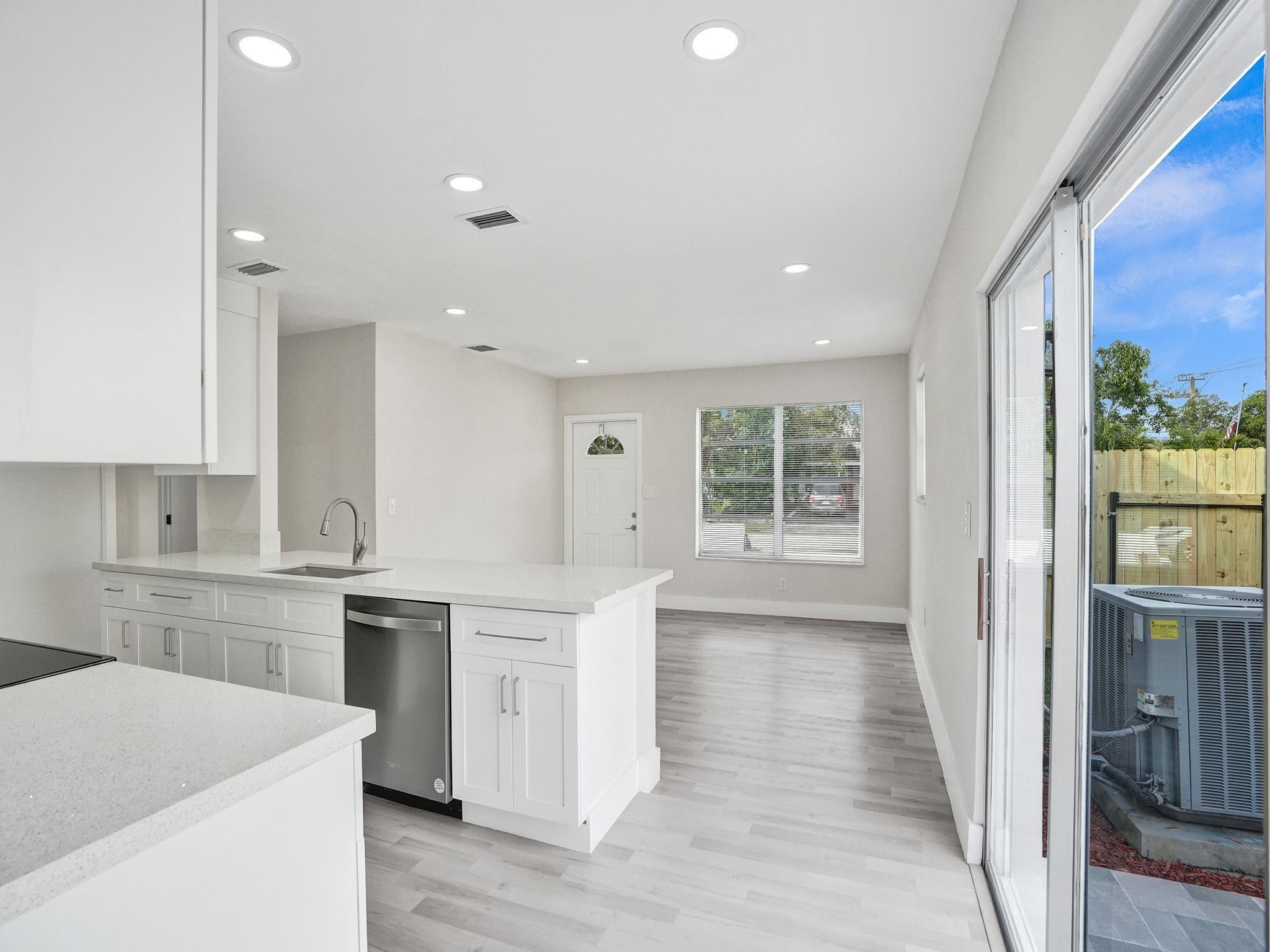 631 North 69th Terrace Hollywood, FL 33024 - Photo 54 of 60 a kitchen with a sink stove and cabinets