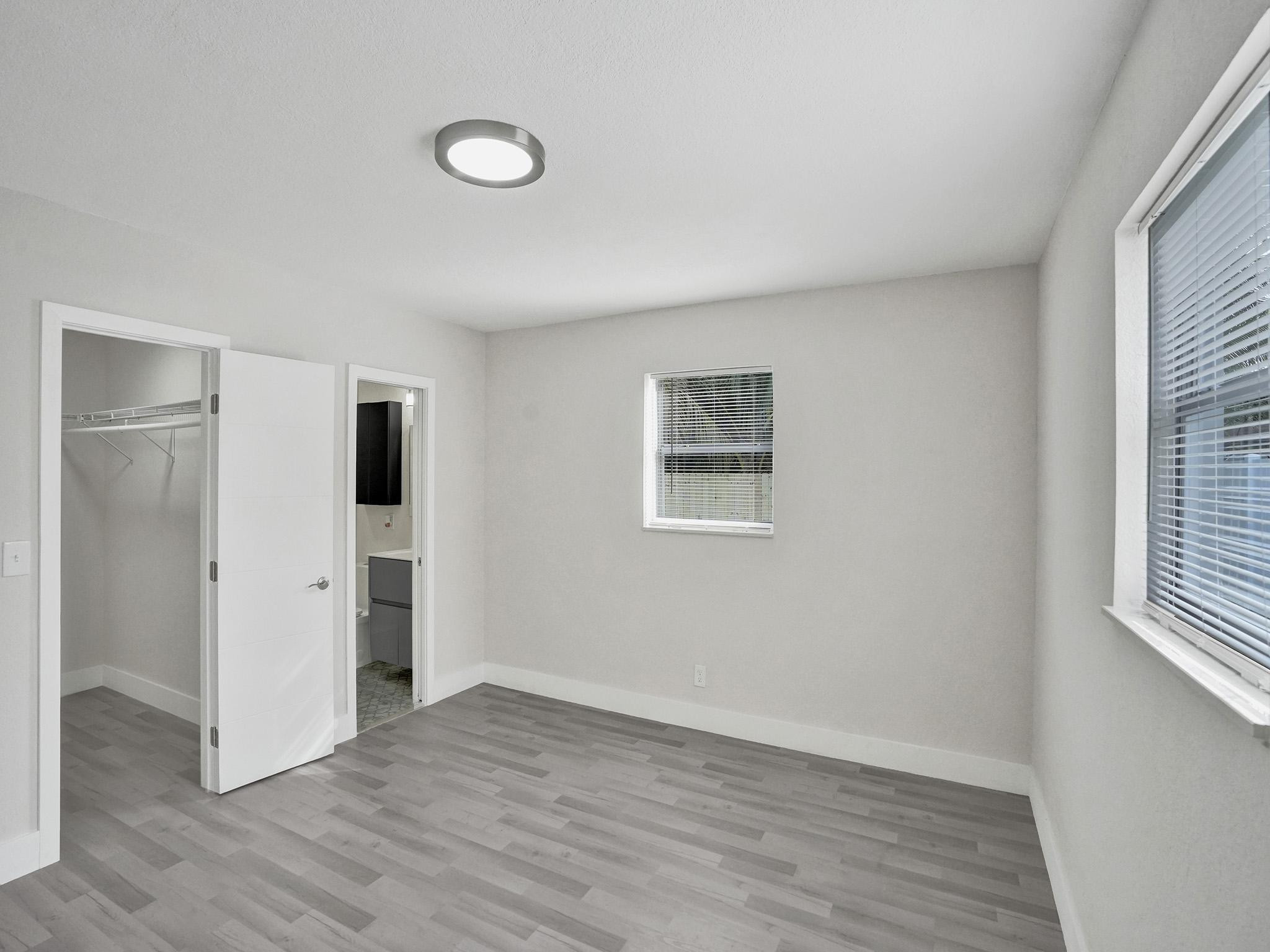 631 North 69th Terrace Hollywood, FL 33024 - Photo 7 of 60 a view of empty room with wooden floor and windows