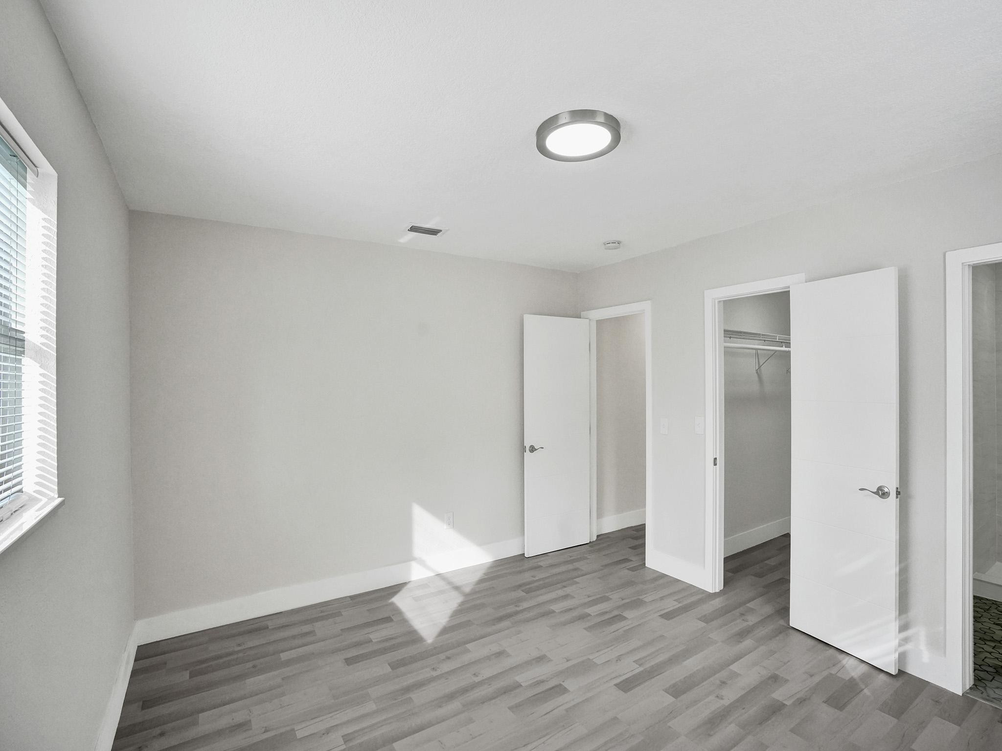 631 North 69th Terrace Hollywood, FL 33024 - Photo 9 of 60 a view of an empty room with wooden floor and window