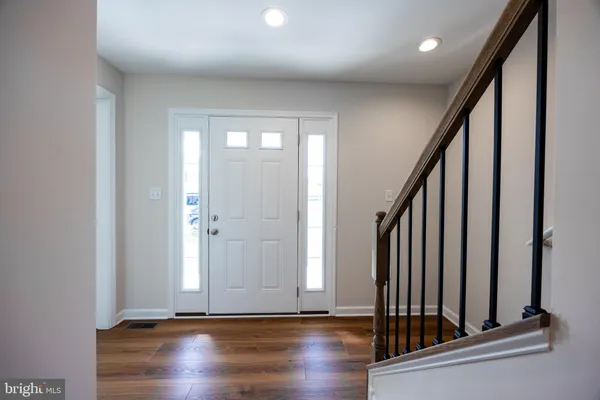 an entryway with wooden floor and door