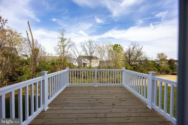 a view of balcony with wooden floor and fence