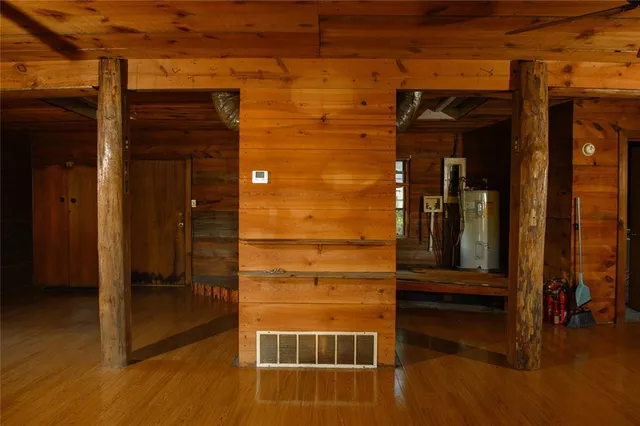 a view of a kitchen with dining area a sink window and wooden floor