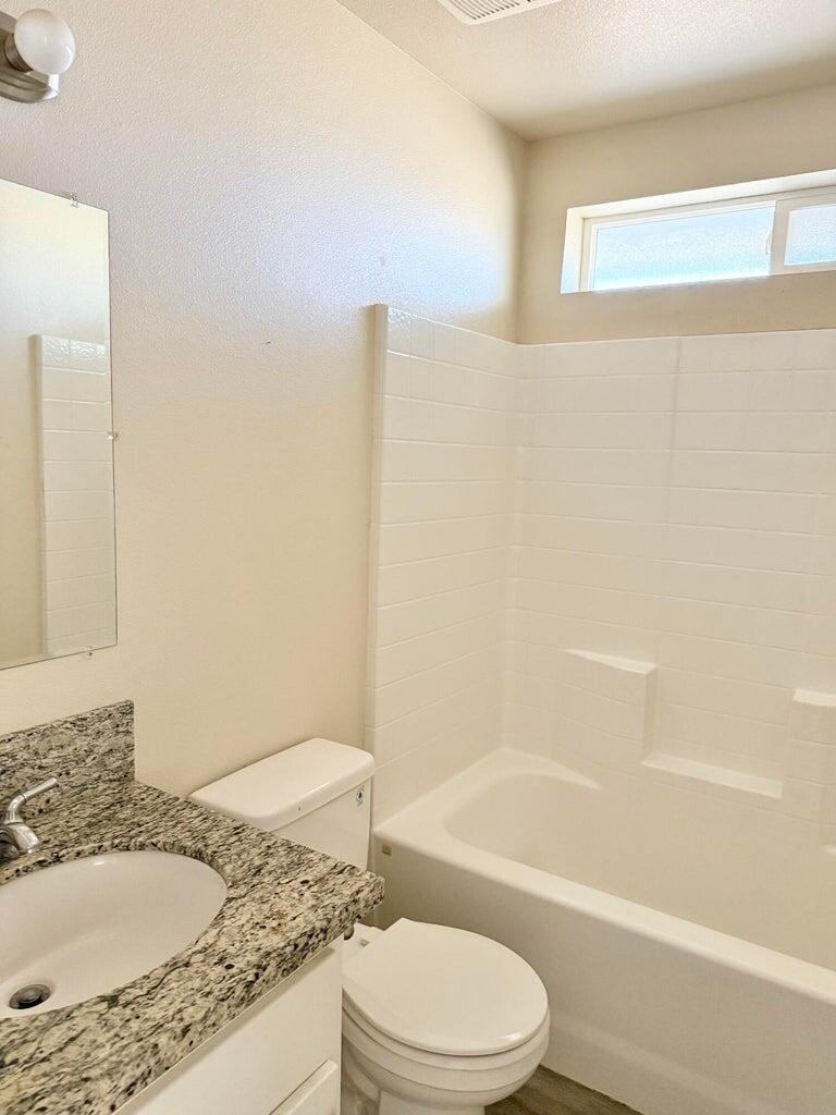 1310 North Belmont Road Exeter, CA 93221 - Photo 15 of 15 a bathroom with a granite countertop sink toilet and shower