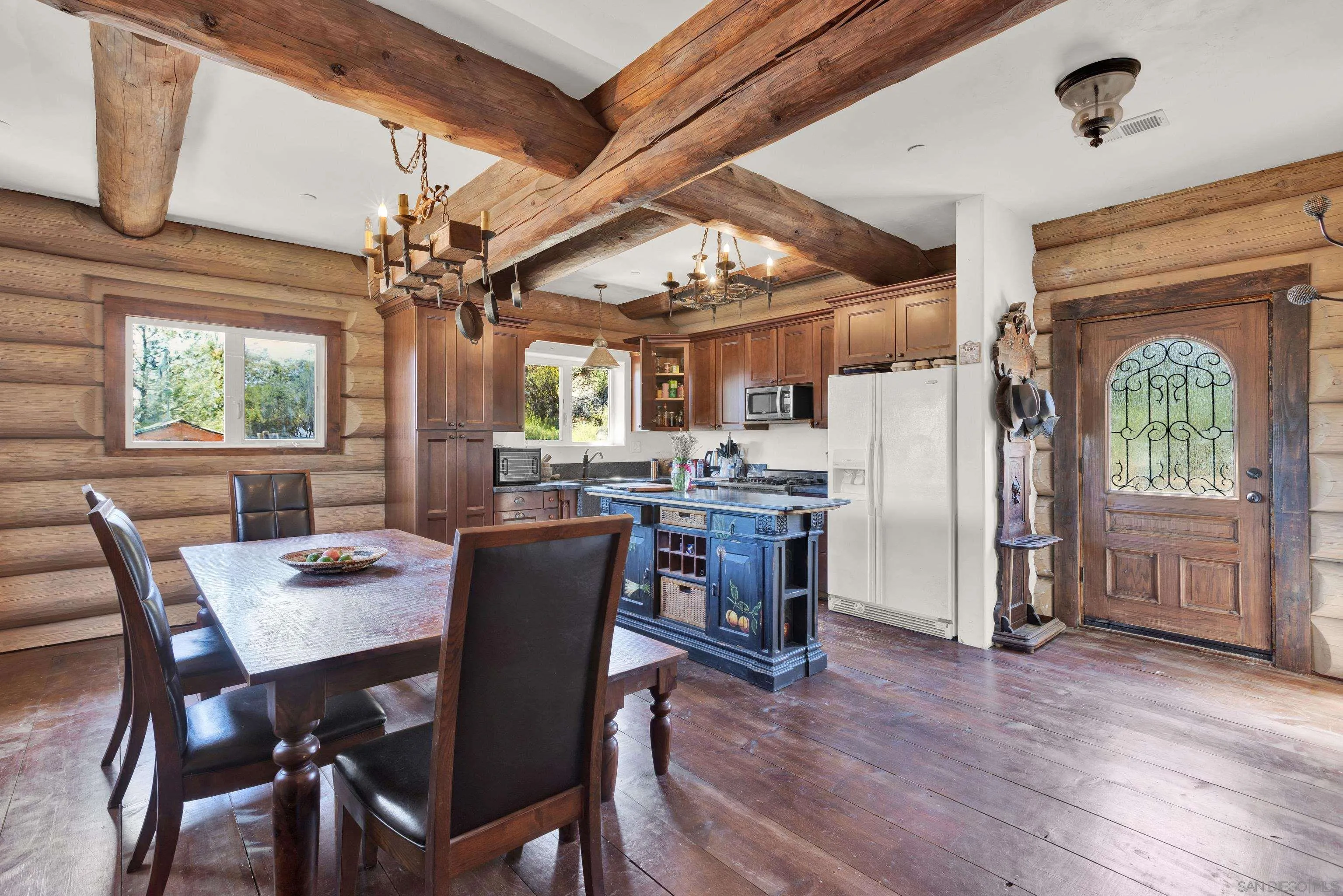 20580 Bexley Road Jamul, CA 91935 - Photo 16 of 50 a dining room with furniture a chandelier and wooden floor