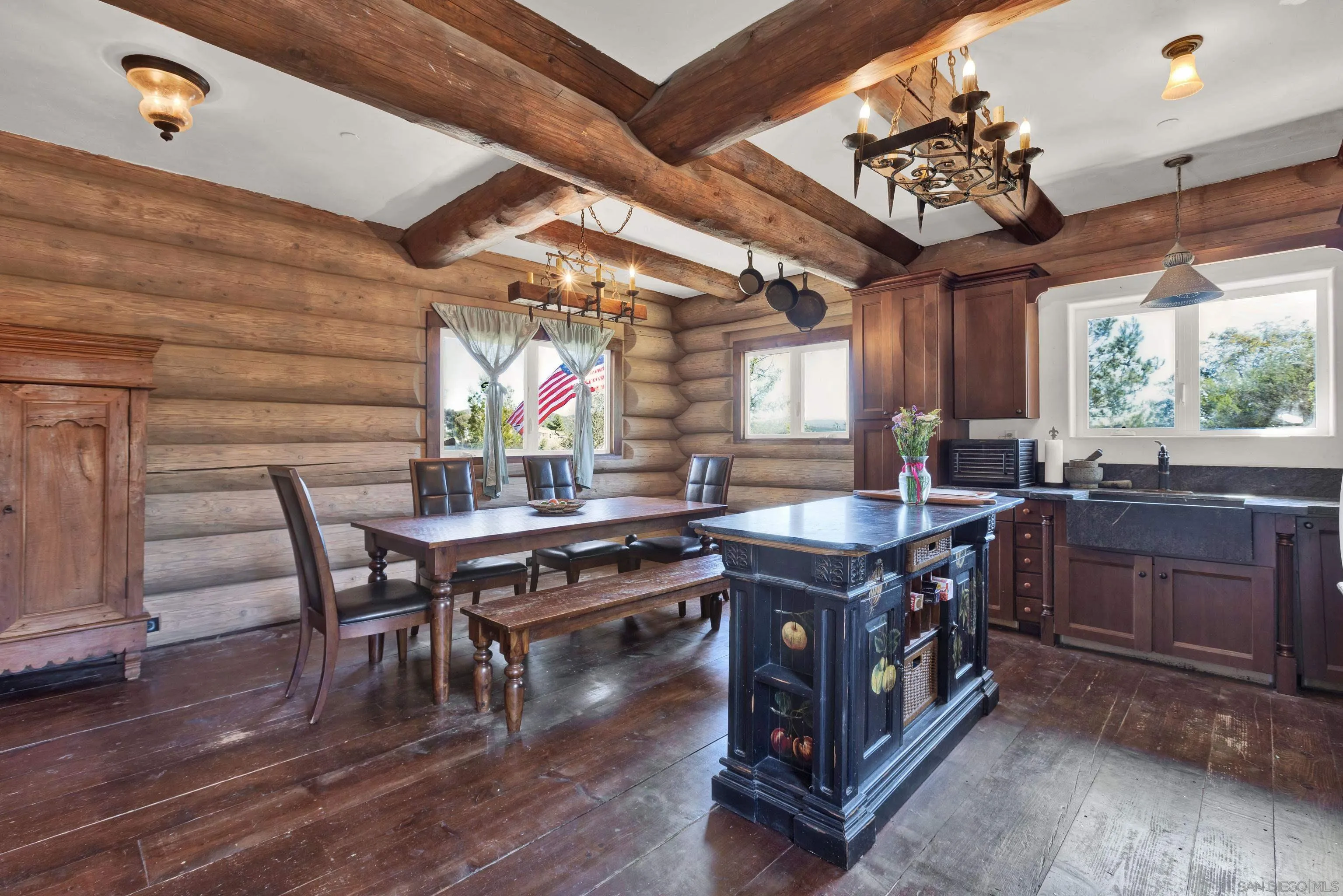 20580 Bexley Road Jamul, CA 91935 - Photo 20 of 50 a kitchen with stainless steel appliances granite countertop a stove a sink dishwasher a dining table and chairs with wooden floor