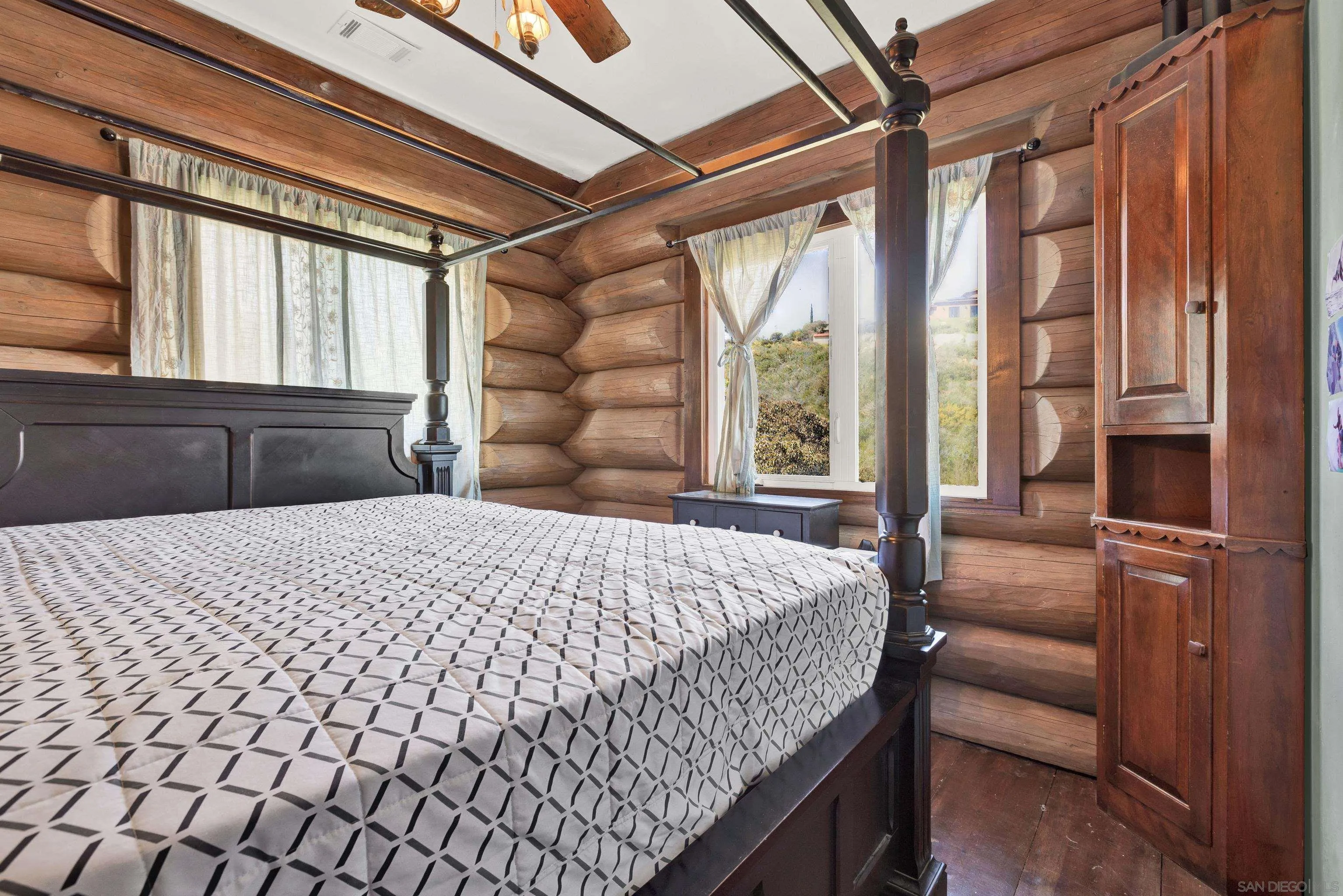 20580 Bexley Road Jamul, CA 91935 - Photo 24 of 50 a bedroom with a bed and wooden floor