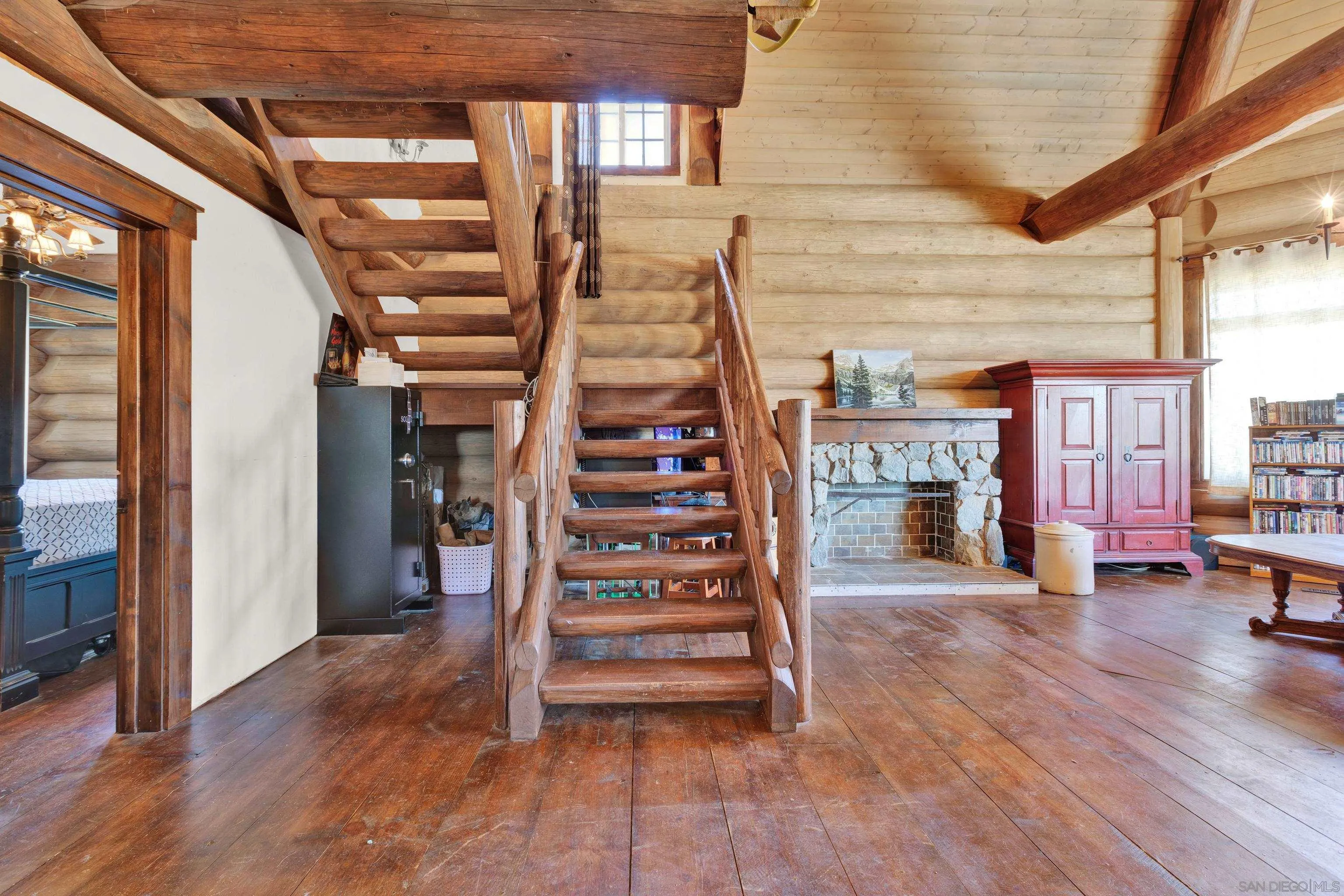 20580 Bexley Road Jamul, CA 91935 - Photo 26 of 50 a view of a hallway with wooden floor fireplace and windows