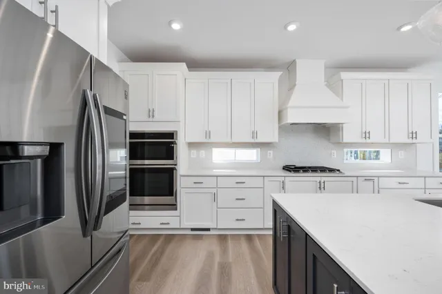 an empty room with windows and a fireplace