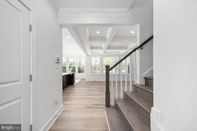 a view of a livingroom with a fireplace wooden floor and a chandelier