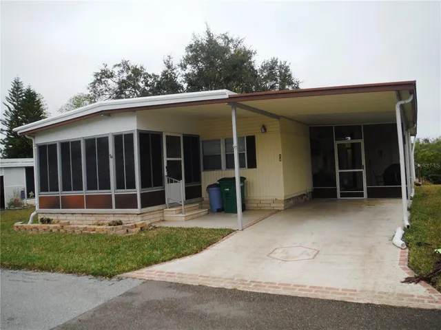 a view of a house with a yard and plants