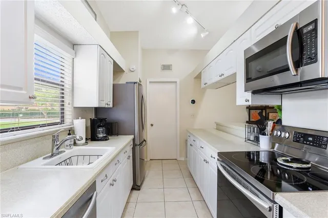 a kitchen with a sink stove and microwave