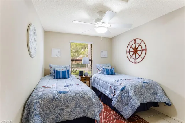 a bedroom with double bed and a chandelier