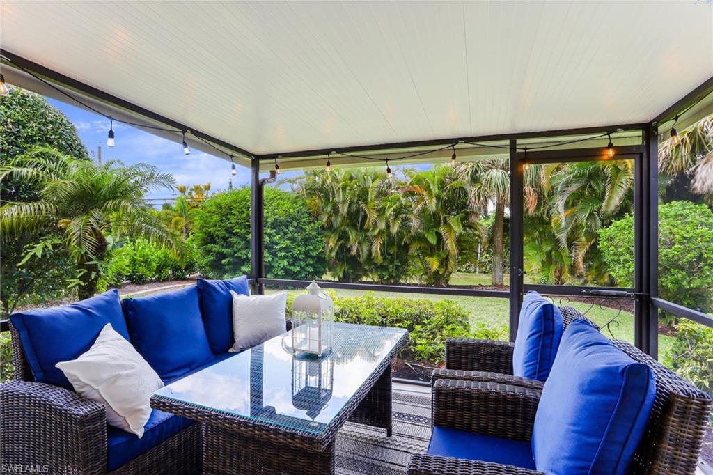 633 91st Avenue North Naples, FL 34108 - Photo 23 of 25 a living room with furniture and a large window