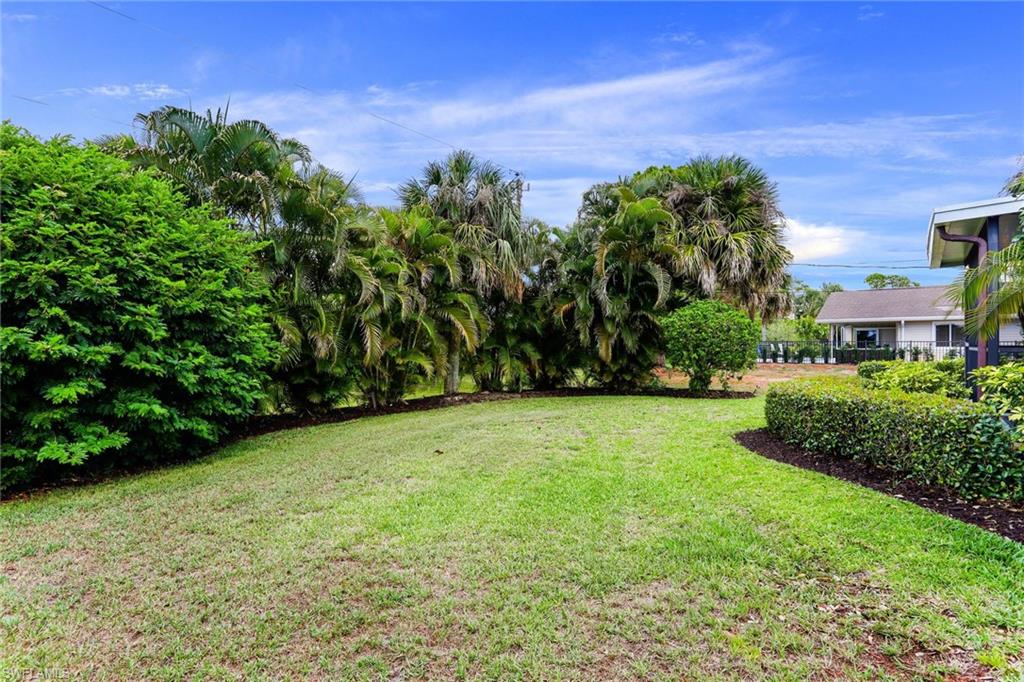 633 91st Avenue North Naples, FL 34108 - Photo 25 of 25 a view of a garden with a building in the background