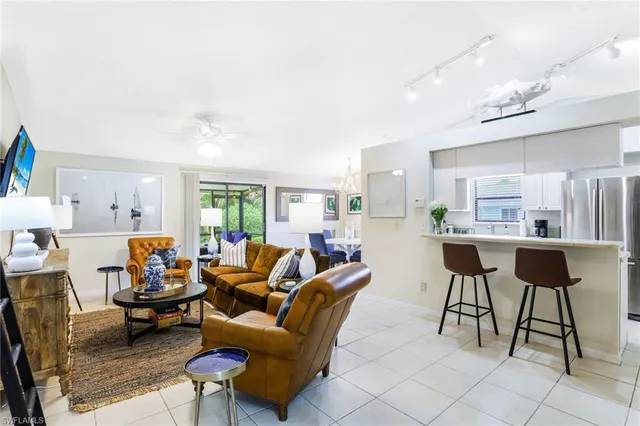 a living room with furniture and a kitchen view