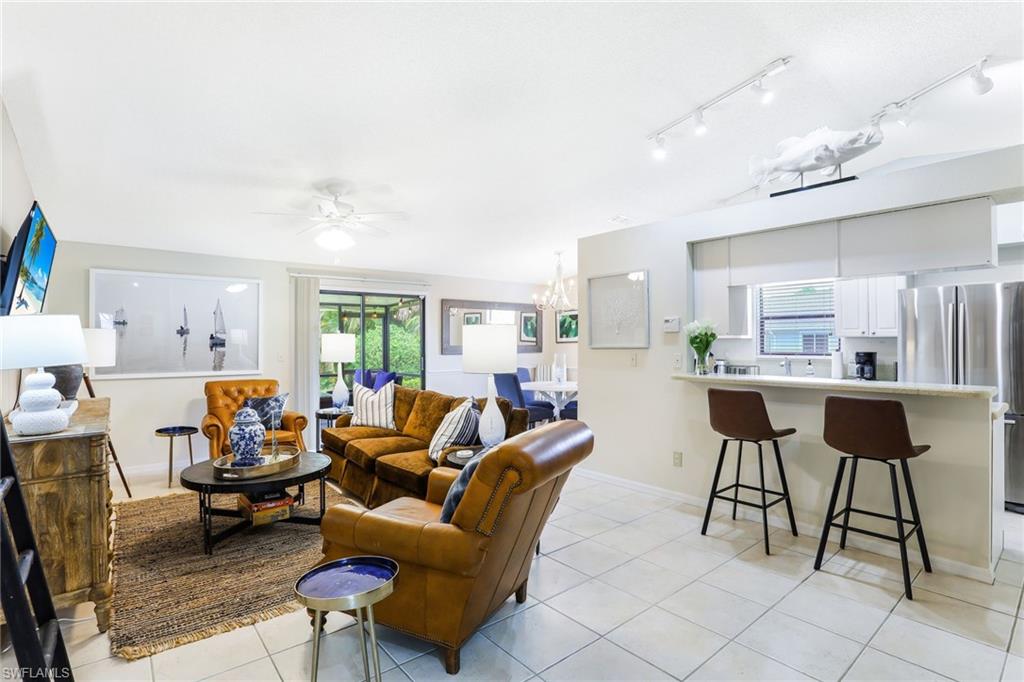 633 91st Avenue North Naples, FL 34108 - Photo 5 of 25 a living room with furniture and a kitchen view