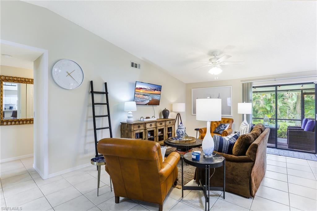 633 91st Avenue North Naples, FL 34108 - Photo 7 of 25 a living room with furniture and a large window
