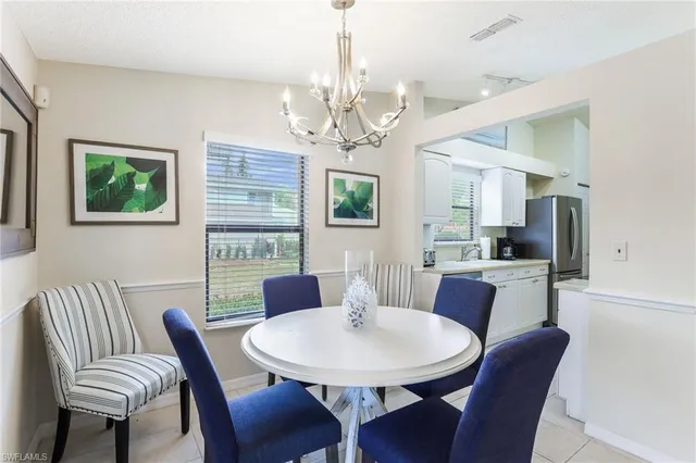 a view of a dining room with furniture a chandelier and window