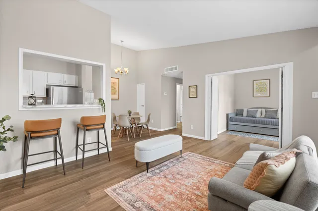 a living room with furniture and a wooden floor