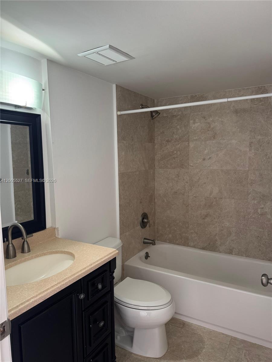 6725 Harding Avenue, Unit 503 Miami Beach, FL 33141 - Photo 11 of 23 a bathroom with a sink a toilet and shower