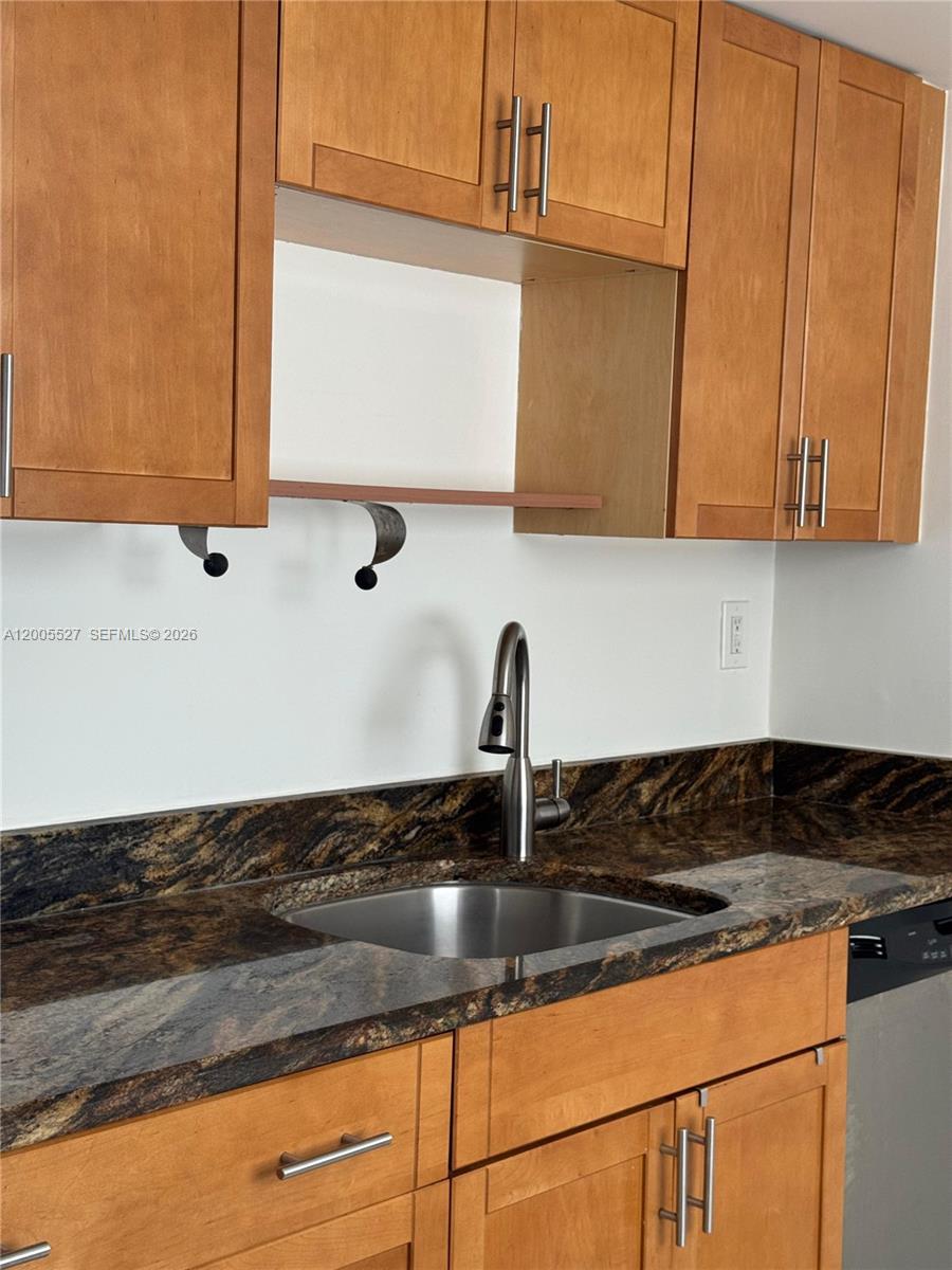 6725 Harding Avenue, Unit 503 Miami Beach, FL 33141 - Photo 12 of 23 a kitchen with granite countertop a sink and a stove